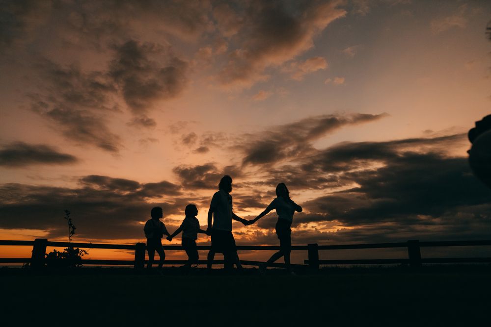 A family walks together at sunset